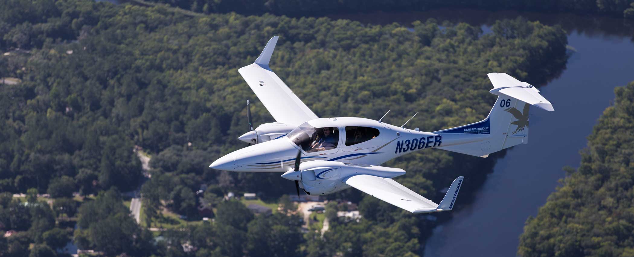 Embry-Riddle Aeronautical University Diamond plane flies over swamp 